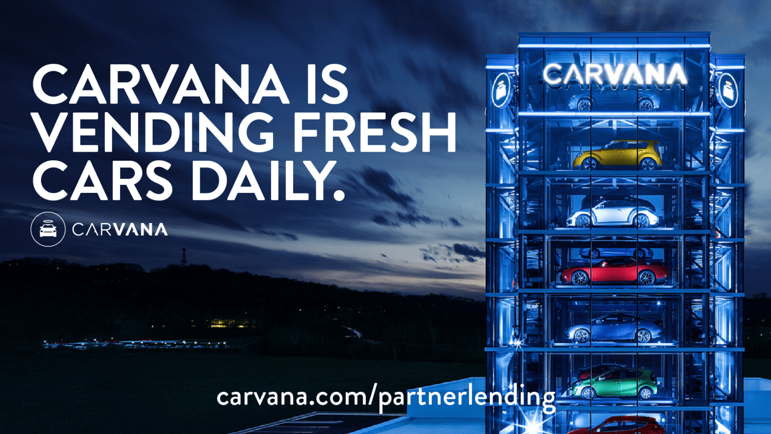 Carvana is Vending Fresh Cars Daily. Carvana.com/partnerlending - Carvana car vending machine holding various cars.