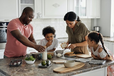 Family in kitchen eating together.